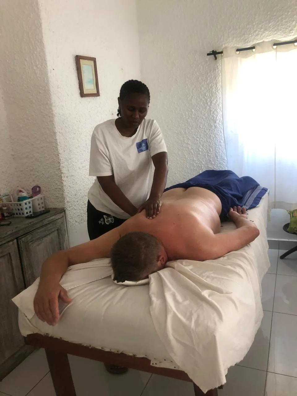 Therapist working on a guest's shoulders during a massage